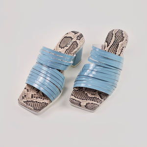 Strappy leather heeled sandals in blue color with a snake pattern insole
